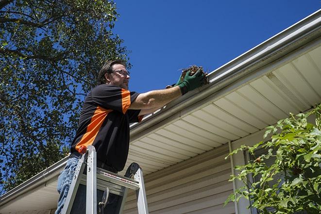 a ladder propped up against a building for gutter repair in Akron